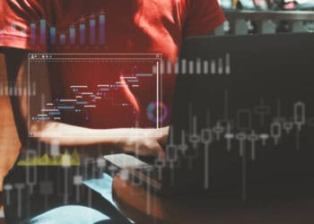 Person working on laptop, Gantt chart displayed. EU trade with Ukraine. - Supply Chain News
