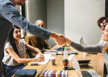 A group of people engaged in economic sanctions and export controls in a meeting room.