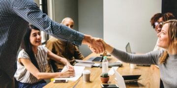 A group of people engaged in economic sanctions and export controls in a meeting room.
