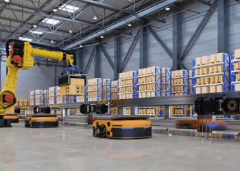 GXO Logistics operates an Automated Logistics Center where robots efficiently navigate the warehouse floor filled with boxes.