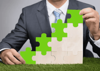 A businessman redefining corporate responsibility, holding a green puzzle piece.