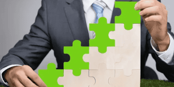 A businessman redefining corporate responsibility, holding a green puzzle piece.