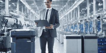 Businessman reviewing data in a smart factory, showcasing AI's transformative power in modern supply chains. - Supply Chain News