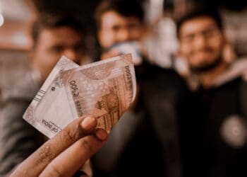 A certified group of people holding up a piece of Crucial Compliance money.