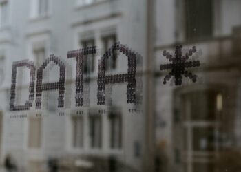 A sign with the word data protection on it in front of a building.