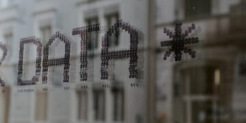 A sign with the word data protection on it in front of a building.