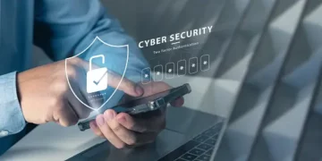 In the future, a man is securely accessing his laptop through an authentication process, protected by a security shield.