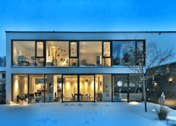 A luxury house in the snow at night, surrounded by a mesmerizing landscape.