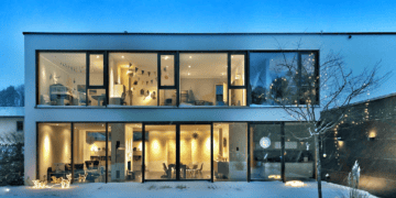 A luxury house in the snow at night, surrounded by a mesmerizing landscape.