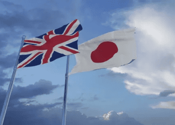 Two British and Japanese flags flying in the sky, symbolizing the potential opportunities for the UK Trade Delegation to enter the Japanese Luxury Goods Market.