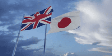 Two British and Japanese flags flying in the sky, symbolizing the potential opportunities for the UK Trade Delegation to enter the Japanese Luxury Goods Market.