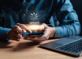 Person using smartphone, progress bar shows "UPDATE..." Digital energy supply chain integration. - Supply Chain News