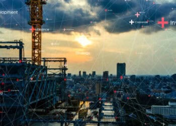 A cityscape featuring construction cranes and a network of connections illustrating digital integration and energy supply chains.