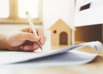 Close-up of hands signing document, pen in hand. Wyoming environmental litigation. - Supply Chain News