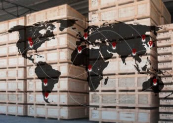 A warehouse with pallets and a map of the world, serving as a hub for the Challenges Global Health Supply Chain Project supported by USAID.