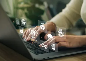 Person using laptop, sustainable supply chain management icons displayed. - Supply Chain News