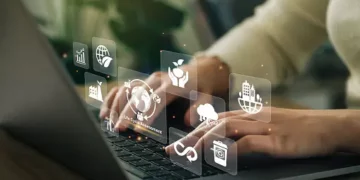 Person using laptop, sustainable supply chain management icons displayed. - Supply Chain News