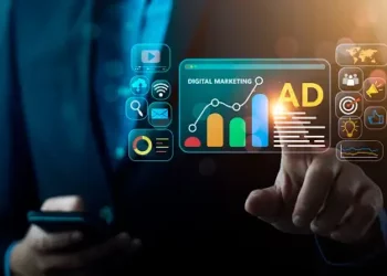 Businessperson interacts with digital marketing interface showing growth graph and "AD" for advertising. Digital marketing strategy. - Supply Chain News