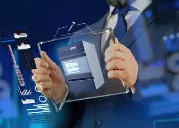 Businessman reviewing a 3D model of an appliance, cybersecurity data displayed. - Supply Chain News