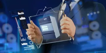 Businessman reviewing a 3D model of an appliance, cybersecurity data displayed. - Supply Chain News