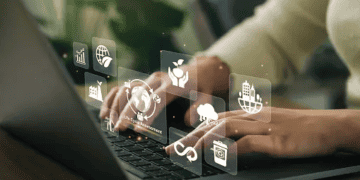 Person using laptop, sustainable supply chain icons displayed. Evolving business strategy. - Supply Chain News