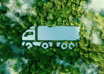 Aerial view of a semi-truck shaped in a forest, illustrating sustainable transportation in the automotive industry. - Supply Chain News