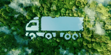 Aerial view of a semi-truck shaped in a forest, illustrating sustainable transportation in the automotive industry. - Supply Chain News