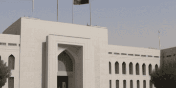A white building with Afghan Central Bank flags flying in front of it, symbolizing independence and US Report influence.