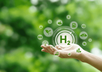 Hand holding a glowing H2 symbol surrounded by green eco icons representing green supply chain management and hydrogen fuel. - Supply Chain News