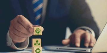 Person placing a block labeled "Environmental" atop blocks reading "Social" and "Governance," illustrating ESG principles. - Supply Chain News