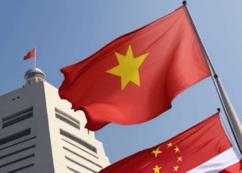 Flags of Vietnam and China waving against a building, symbolizing rising tensions in the region. - Supply Chain News