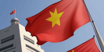 Flags of Vietnam and China waving against a building, symbolizing rising tensions in the region. - Supply Chain News