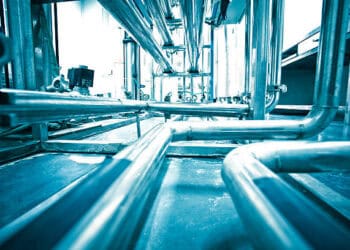 Industrial piping system; complex network of metal pipes and valves. - Supply Chain News