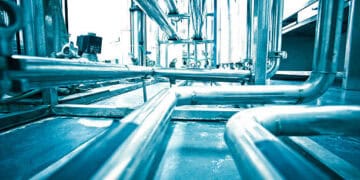 Industrial piping system; complex network of metal pipes and valves. - Supply Chain News