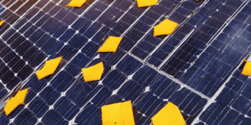 An analysis of the impact of solar tariffs on a solar panel covered in yellow pieces of paper.