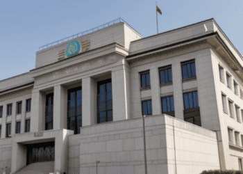 Turkey's Central Bank raises interest rate exceeding expectations, with a building displaying a flag on top.