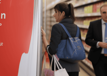 A woman in a suit engaged in a meeting discussing the cost-of-living crisis in the UK.