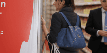 A woman in a suit engaged in a meeting discussing the cost-of-living crisis in the UK.