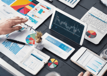 Businesspeople reviewing data charts and graphs on tablets and laptops, analyzing logistics and supply chain information. - Supply Chain News