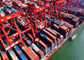 An aerial view of a container port in Shanghai, highlighting China's bustling trade and the impact of 2020 Tariff Adjustments.