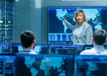 Cybersecurity experts at Con Edison conference, reviewing data on multiple monitors. - Supply Chain News