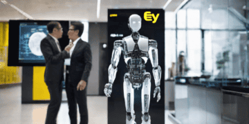 A humanoid robot stands in an office lobby, with two businesspeople in the background. The EY logo is visible. - Supply Chain News