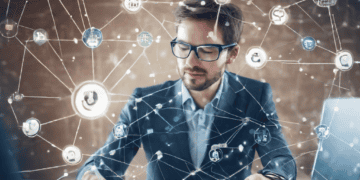 A businessman sitting at a desk, surrounded by a network of AI icons enhancing Electronic Data Interchange (EDI).