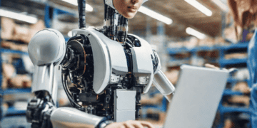 AI robot using laptop in warehouse, enhancing supply chain efficiency. - Supply Chain News