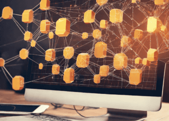 Computer screen displays a network of interconnected orange cubes, illustrating distributed ledger technology. - Supply Chain News