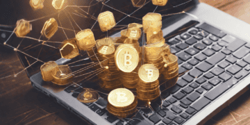 Golden Bitcoin stacks on laptop; blockchain technology use case. - Supply Chain News