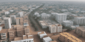 An aerial view of Accra, a city experiencing a diaspora influx, with many buildings rising due to the escalating cost of living.