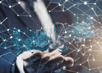 A businessman's hand is holding a network of dots and lines while exploring Research Collaborations at the Monash University's Blockchain Technology Centre.