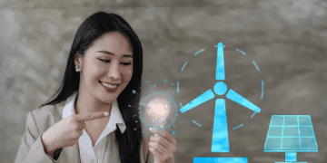 Woman pointing to a glowing lightbulb, representing clean energy solutions like wind and solar power. - Supply Chain News