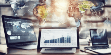 Three laptops display global data, illustrating technology's impact on the global economy. - Supply Chain News